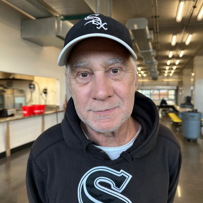 Man wearing Chicago White Sox Hat smiling